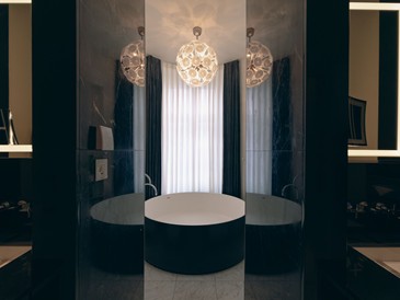 Modern bathroom with a freestanding bathtub and stylish lighting.