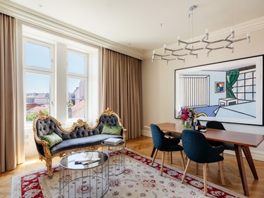 Elegant suite at Sans Souci Vienna with antique sofa and contemporary art.